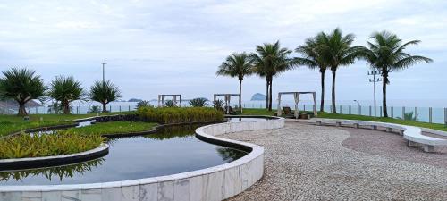 un parque con palmeras y un estanque con bancos en Hotel Nacional Rio de Janeiro, en Río de Janeiro