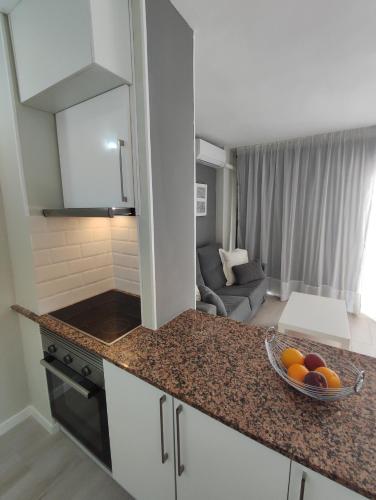 a kitchen with a bowl of fruit on a counter at Salou Sol in Salou