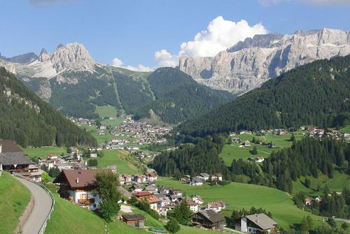 a small town in a valley in the mountains at Apartments Mauriz in Selva di Val Gardena