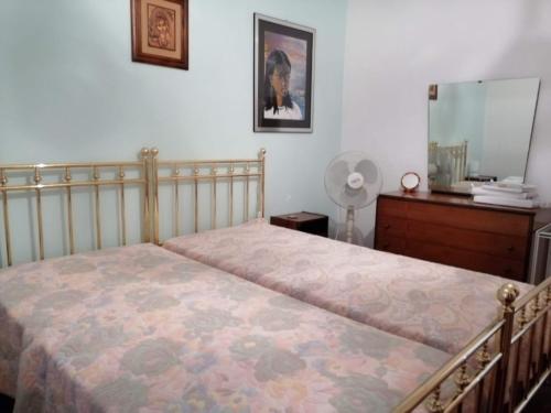 a bedroom with a bed and a dresser and a mirror at Sirolo - Pesciolino Azzurro in Sirolo