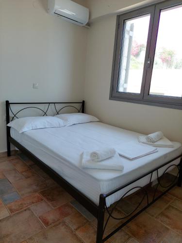 a bed in a room with two towels on it at Golden Sunrise in Gythio