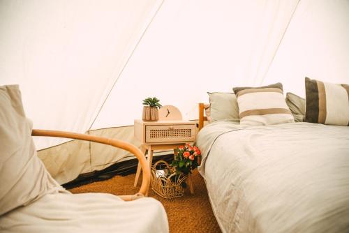 a bedroom with two beds and a tent at Stoffhaus in Skipton