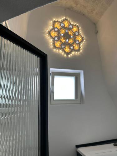 a chandelier hanging above a door in a room at AccalmiA in Monopoli