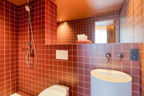 a bathroom with a toilet and a sink and a shower at Maison Arya in Brussels