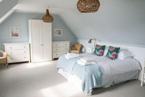 a bedroom with a bed and a dresser at Highfield in Lauder