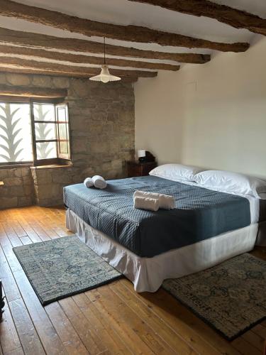 a bedroom with a large bed with two rugs on it at Vila-seca, vine i desconnecta! in Aguilar de Segarra