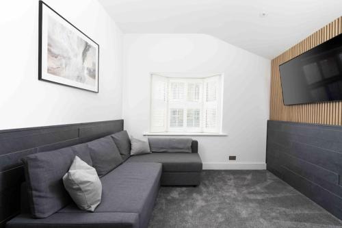 a living room with a couch and a flat screen tv at Stunning new fully renovated flat in Marazion in Marazion