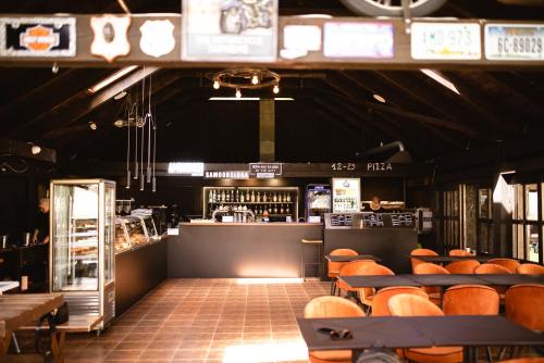 a restaurant with tables and chairs and a bar at Marina Lester Club in Rydzewo