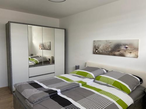 a bedroom with a bed and two mirrors at Ferienwohnung Zur alten Dorfschule in Lünebach