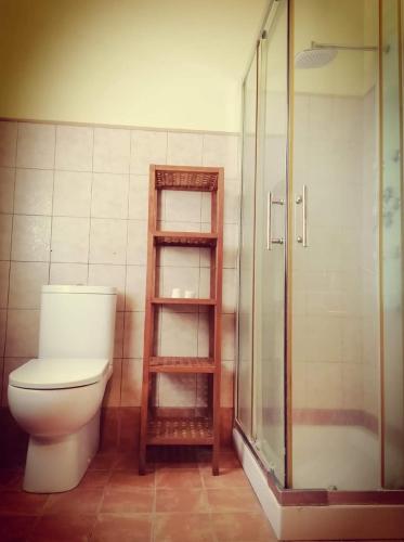 a bathroom with a toilet and a glass shower at Villa Valden in Nunziata