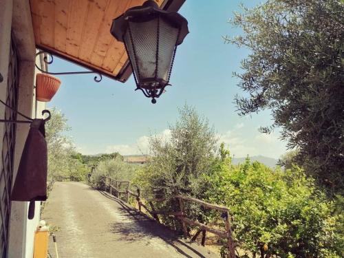 a lamp on a building next to a dirt road at Villa Valden in Nunziata