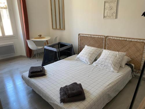 une chambre avec un lit avec deux serviettes dessus dans l'établissement Le studio en Provence, à Saint-Didier