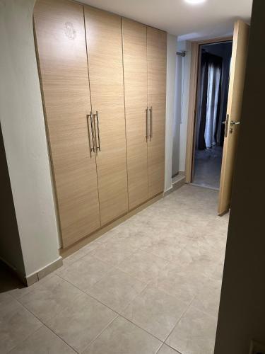 a room with wooden cabinets and a tile floor at Luxury Villa Magic View 4U - katarina in Kineta