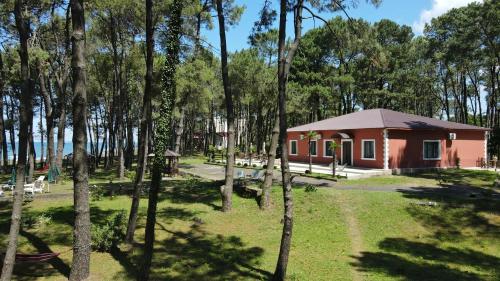 a small red building in the middle of a forest at OXYGEN Shekvetili in Shekvetili