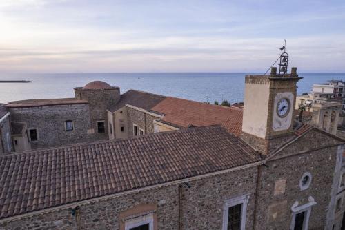 an old building with a clock tower on top of it at Al Vicolo Comfort Room in SantʼAgata di Militello