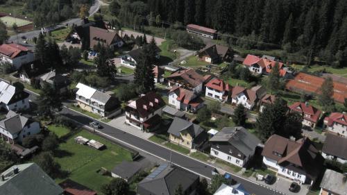 an aerial view of a town with houses and a road at Apartmany Železná Ruda in Železná Ruda