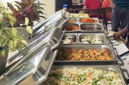 a buffet with many trays of food on a table at MYH - Lake Front Pvt Villa with Staff and Includes FREE Breakfast of your choice in Bandaragama