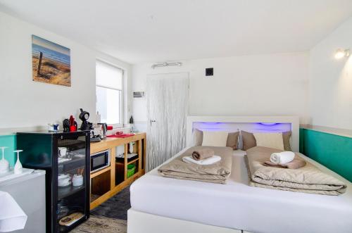 a bedroom with a bed with two pillows on it at Spawo mit Sauna und Whirpool in Pfullendorf