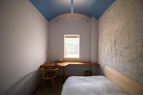 Un pat sau paturi într-o cameră la Megurimegurasu