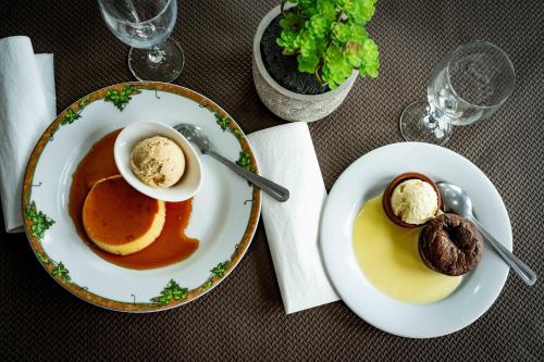 a table with two plates of food on a table at Logis Hôtel La crémaillère in Hagetmau