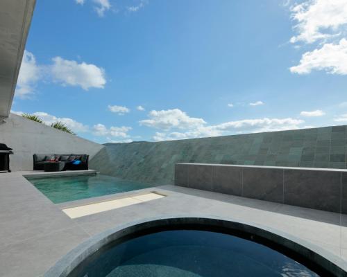 a swimming pool in the backyard of a house at VILLA WHITE in Sesoko