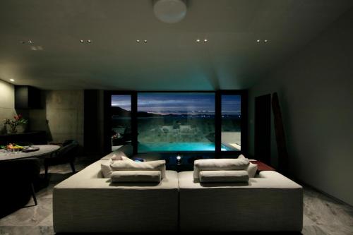 a room with a large bed and a swimming pool at VILLA WHITE in Sesoko
