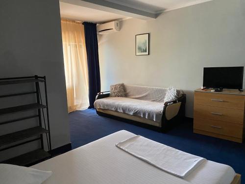 a room with a couch and a tv and a dresser at CHALET Orsova in Orşova