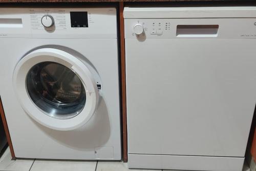 a washing machine and a dryer sitting next to each other at Kingfisher 15 - Home away from home in Margate