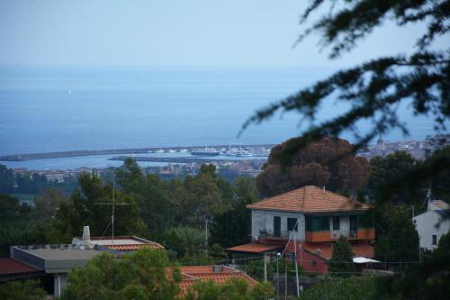 a house on a hill with a view of the water at Triskelion in Nunziata