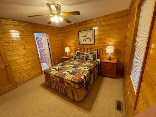 a bedroom with a bed and a ceiling fan at The Lake House At Dale Hollow! in Alpine
