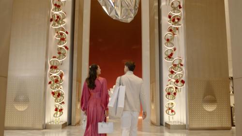 a man and a woman walking down a hallway at Four Seasons Hotel Kuwait at Burj Alshaya in Kuwait