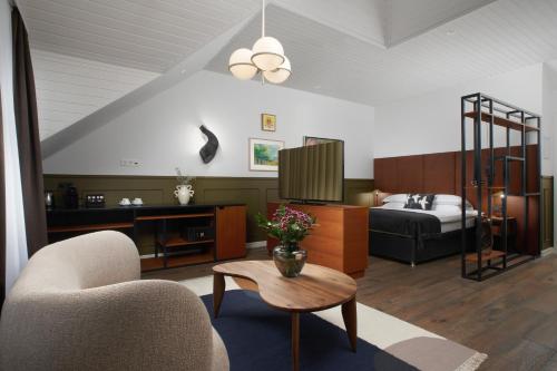a living room with a bed and a couch and a table at Alda Hotel Reykjavík in Reykjavík