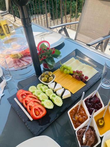 una mesa cubierta con queso y carnes y hortalizas en Panorama Pearl Sea View, en Balchik