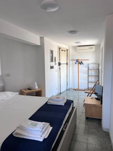 a bedroom with a bed with towels on it at Appartamento con ampio Terrazzo in Rome