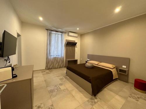 a bedroom with a bed and a television in it at B&B Residenza De Rose in Cosenza