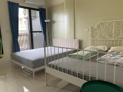 a bedroom with two bunk beds and a balcony at Duke 369 in Donggang