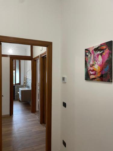a painting of a woman hanging on a wall at Tulip’house in Sant'Albino