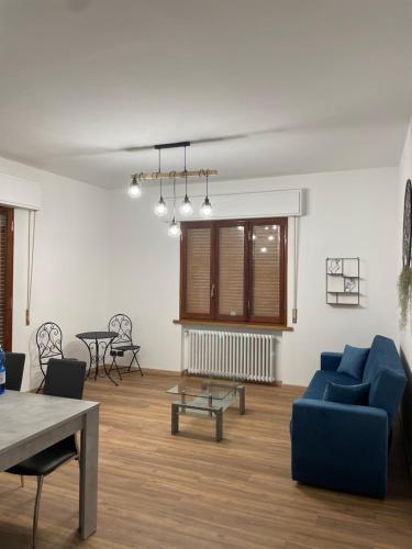 a living room with a blue couch and a table at Tulip’house in Sant'Albino