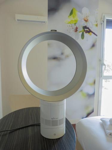 a mirror sitting on top of a table at Hôtel la Verriaire - The Originals in La Verrie