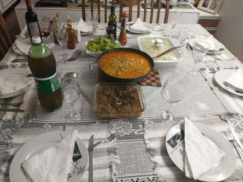 a table with a table cloth with a table with a bowl of food at QUARTO TRIPLO - AMPLO E CONFORTAVEL-PERTO DO CENTRO DE CONVENÇÕES-RECIFE-Pe in Recife