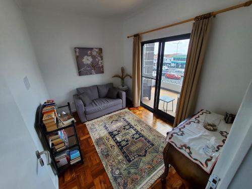 a living room with a couch and a table at Pousada da Vila in Vila Franca do Campo