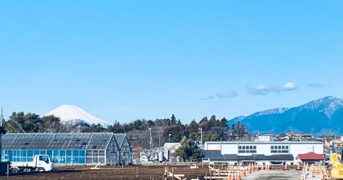 a city with mountains in the background and a building at Shonan no Oka no Villa - Vacation STAY 38385v in Fujisawa
