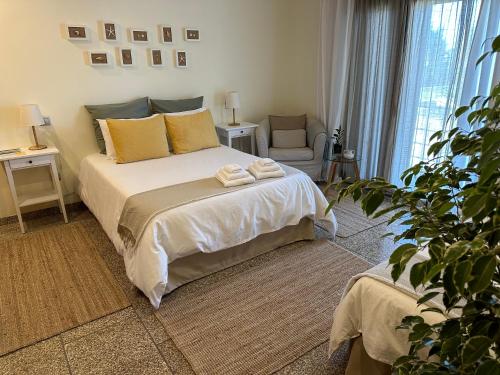 a bedroom with a bed with two towels on it at Casa de Praia Guest House in Labruge