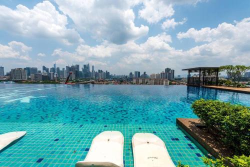 a swimming pool with a city skyline in the background at Skyring Homestay 5min to KLCC in Kuala Lumpur