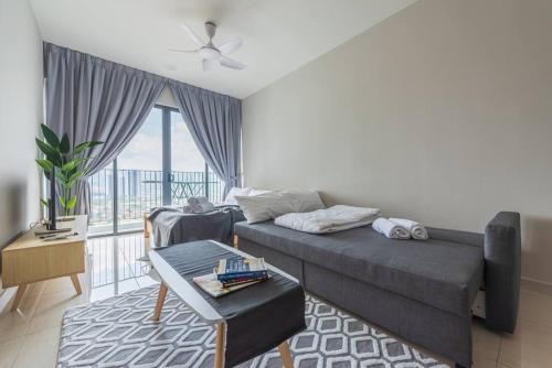 a living room with a couch and a table at Skyring Homestay 5min to KLCC in Kuala Lumpur