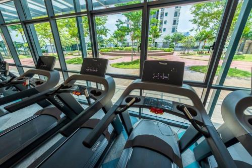 a row of cardio machines in a gym at Skyring Homestay 5min to KLCC in Kuala Lumpur