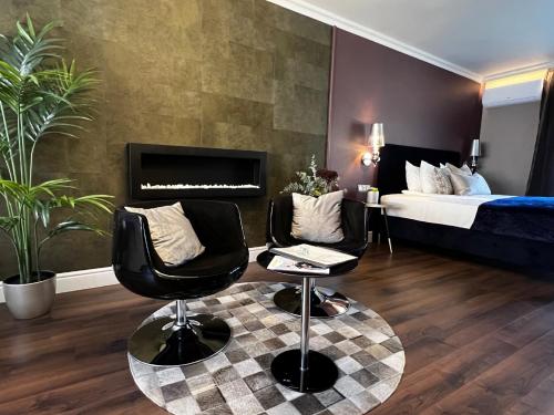 a hotel room with two chairs and a bed at Margaréta Garden & SPA in Eger