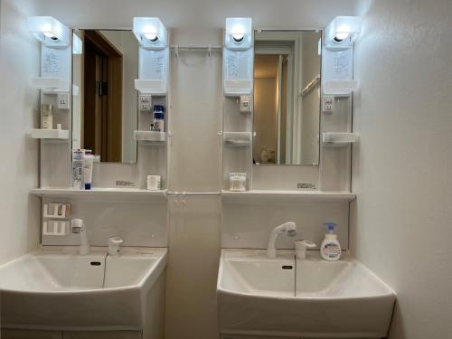 a bathroom with a sink and a mirror at Inari-Home in Kyoto