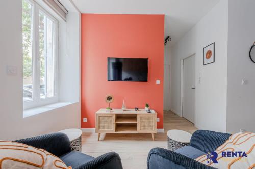 a living room with orange walls and a tv at Chez Yvette 1 Ground floor Near the sea in Leucate