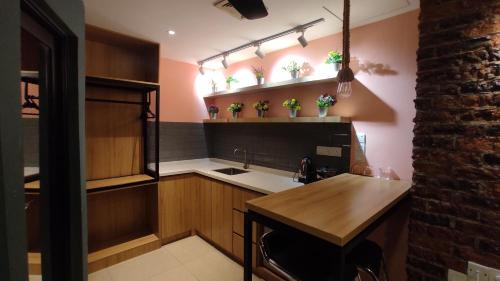 a kitchen with a sink and a counter with potted plants at Smile Hotel C180 Cheras Selatan in Cheras